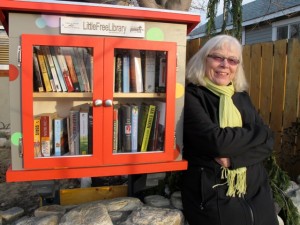 Allison Howard, beside her Little Free Library. For more about this initiative, see http://littlefreelibrary.org